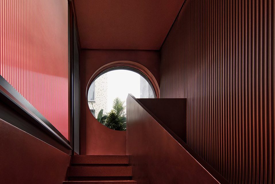 簡約侘寂風(fēng)飲片店樓梯拐角處圓形窗戶效果圖